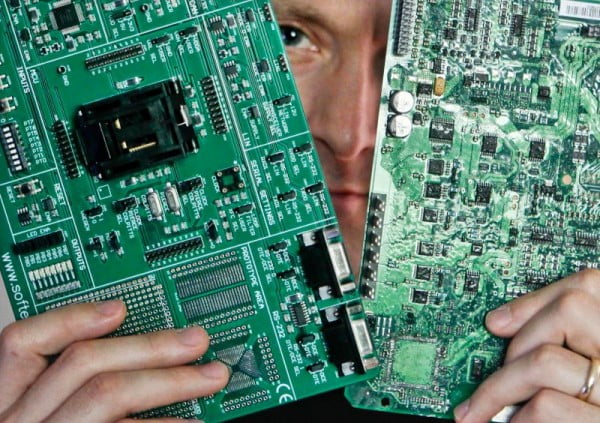 Security researcher Charlie Miller holds two automobile electronic control module circuit boards while posing in his home-office in Wildwood, Missouri, April 30, 2013. Miller, who previously worked for the National Security Agency (NSA), is a security researcher at Twitter. Picture taken April 30, 2013. To match Special Report USA-CYBERWEAPONS/   / REUTERS/Sarah Conard (UNITED STATES- - Tags: CRIME LAW SCIENCE TECHNOLOGY)